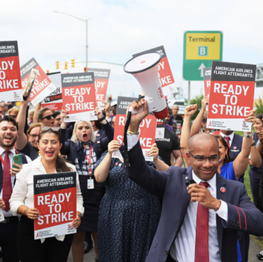 American Airlines flight attendants protesting with signs that say 'Ready to Strike'